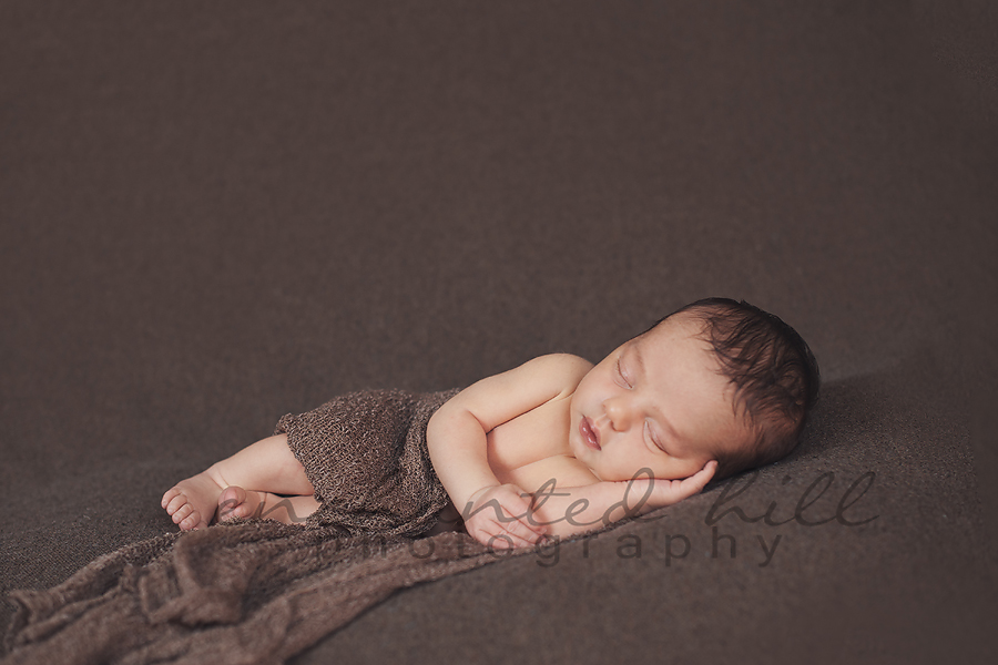 Baby sleeping with brown blanket