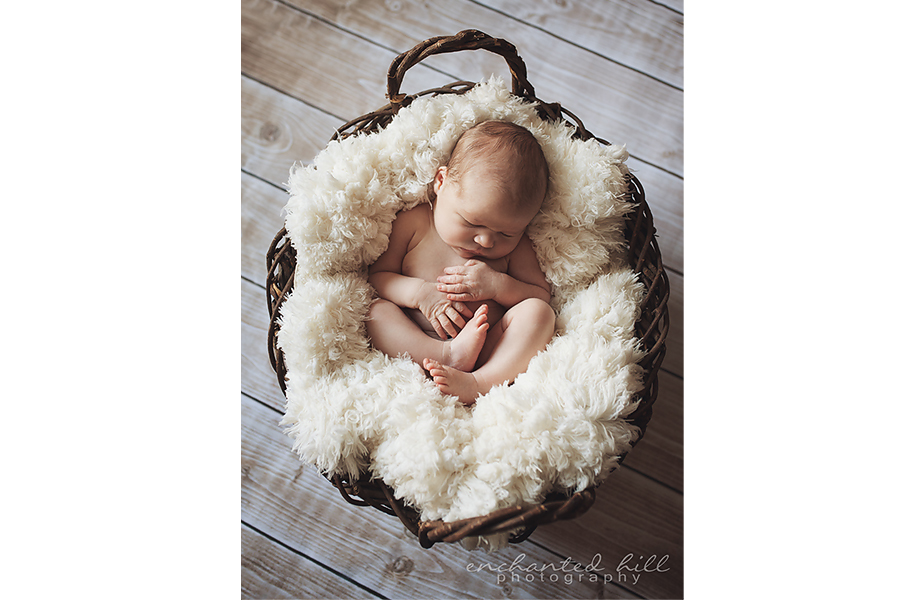 baby sleeping in basket 