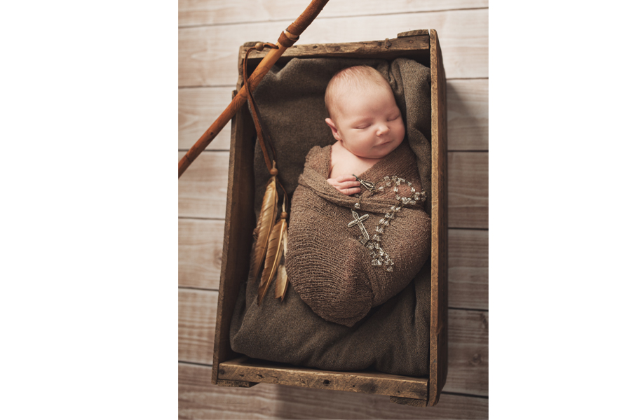 baby in wood crate