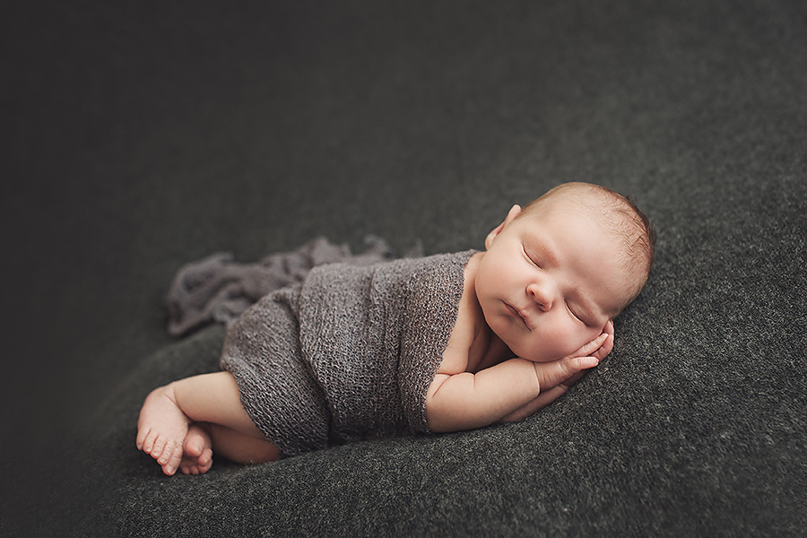 baby sleeping with grey blanket