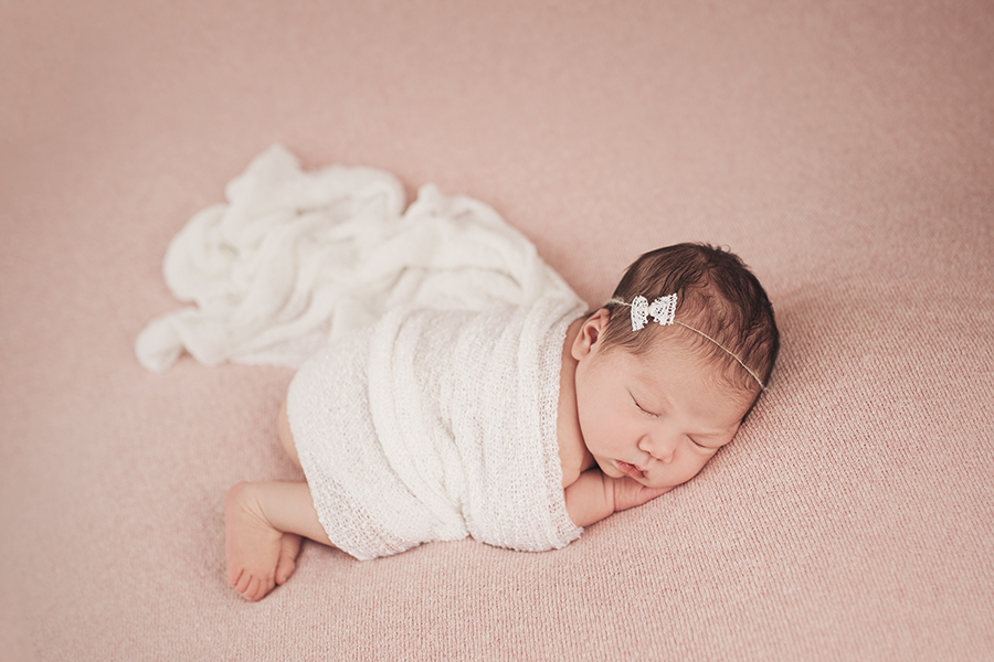 Baby girl all curled up with blanket