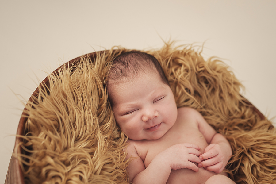 newborn baby smiling