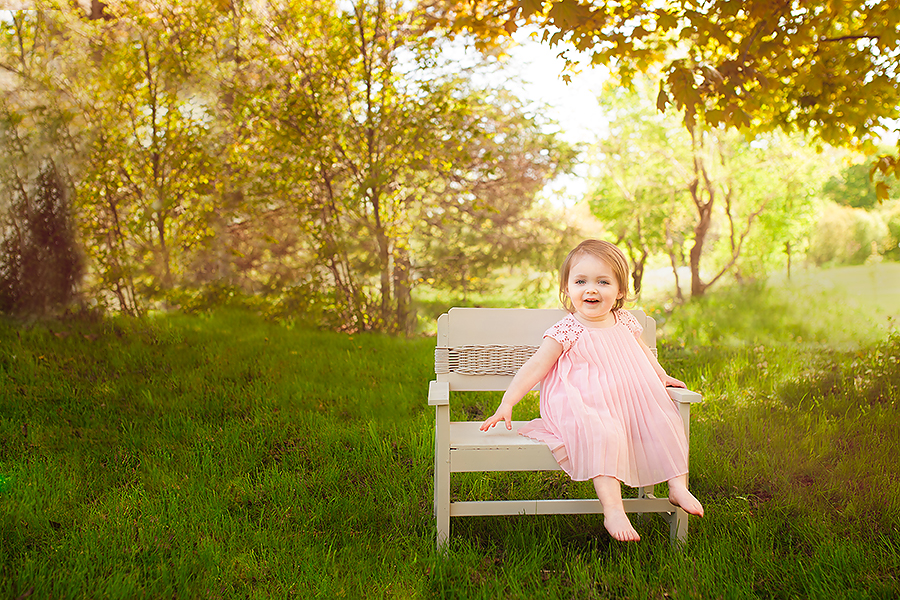 Little girl in pink dress smiling at the camera
