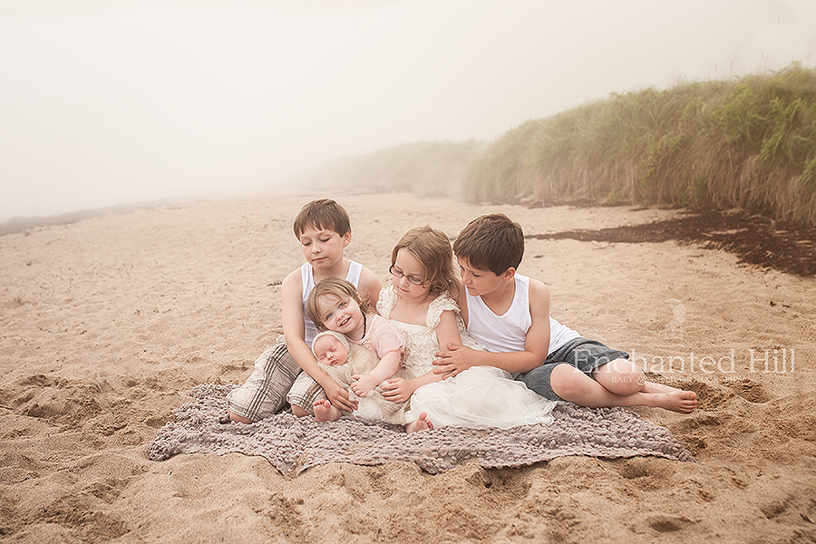 five children sitting on New River Beach New Brunswick