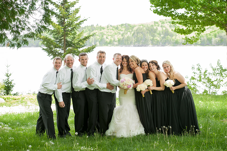 a wedding party stadnign together for their formal pictures at Lake Utopia