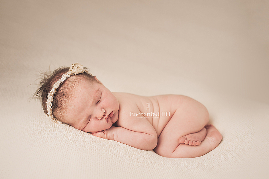 modern newborn images of a newborn curled up sleeping