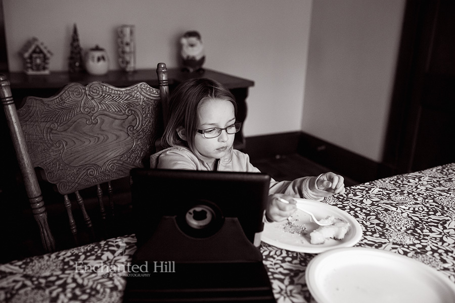 Black and white of a little girl looking at an iPad