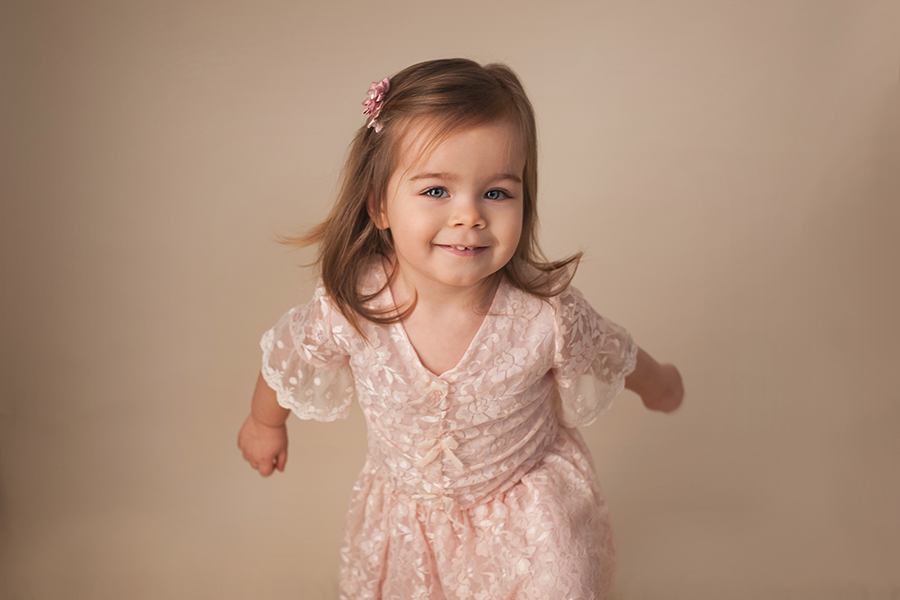 little girl who is dancing in a pink dress