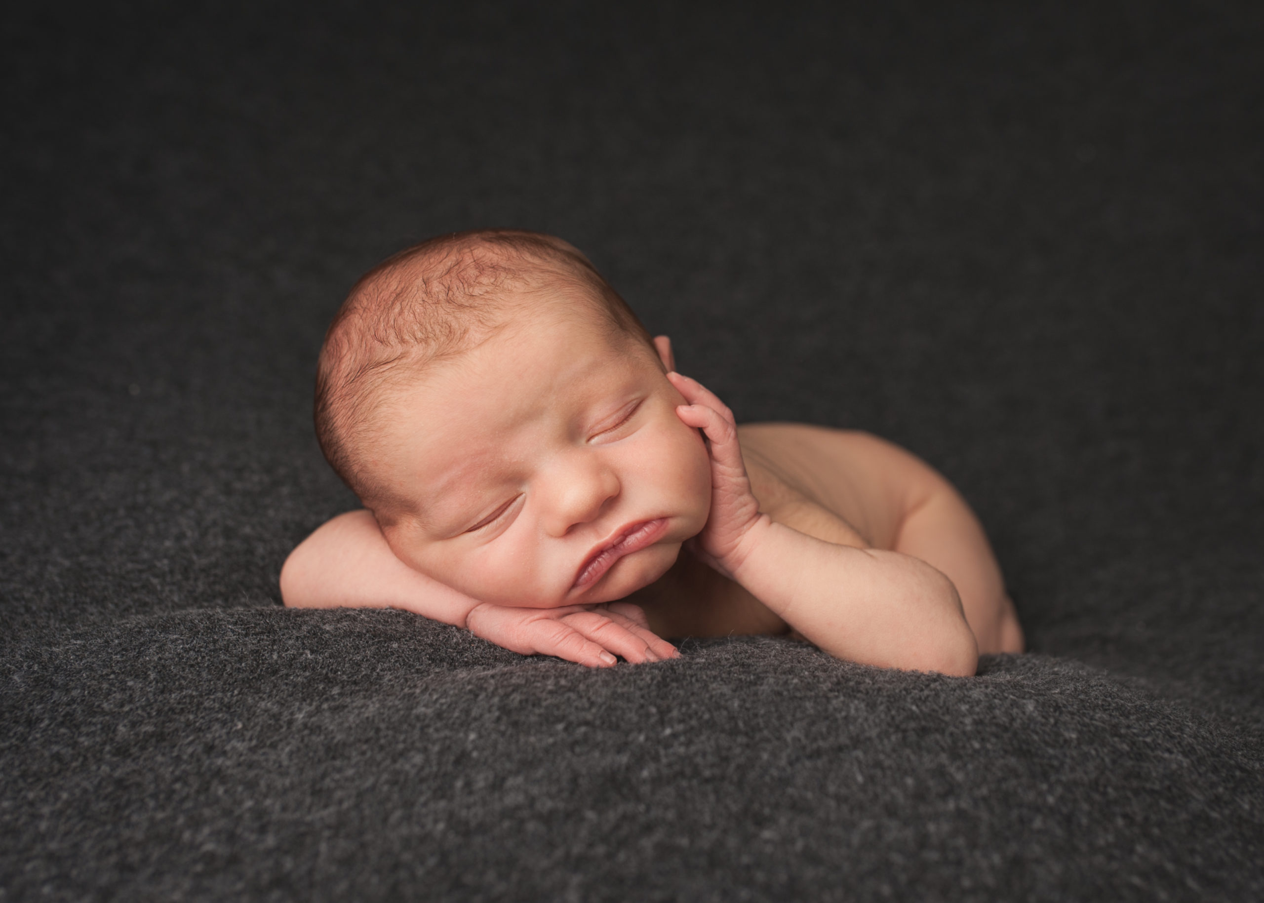 newborn baby on grey