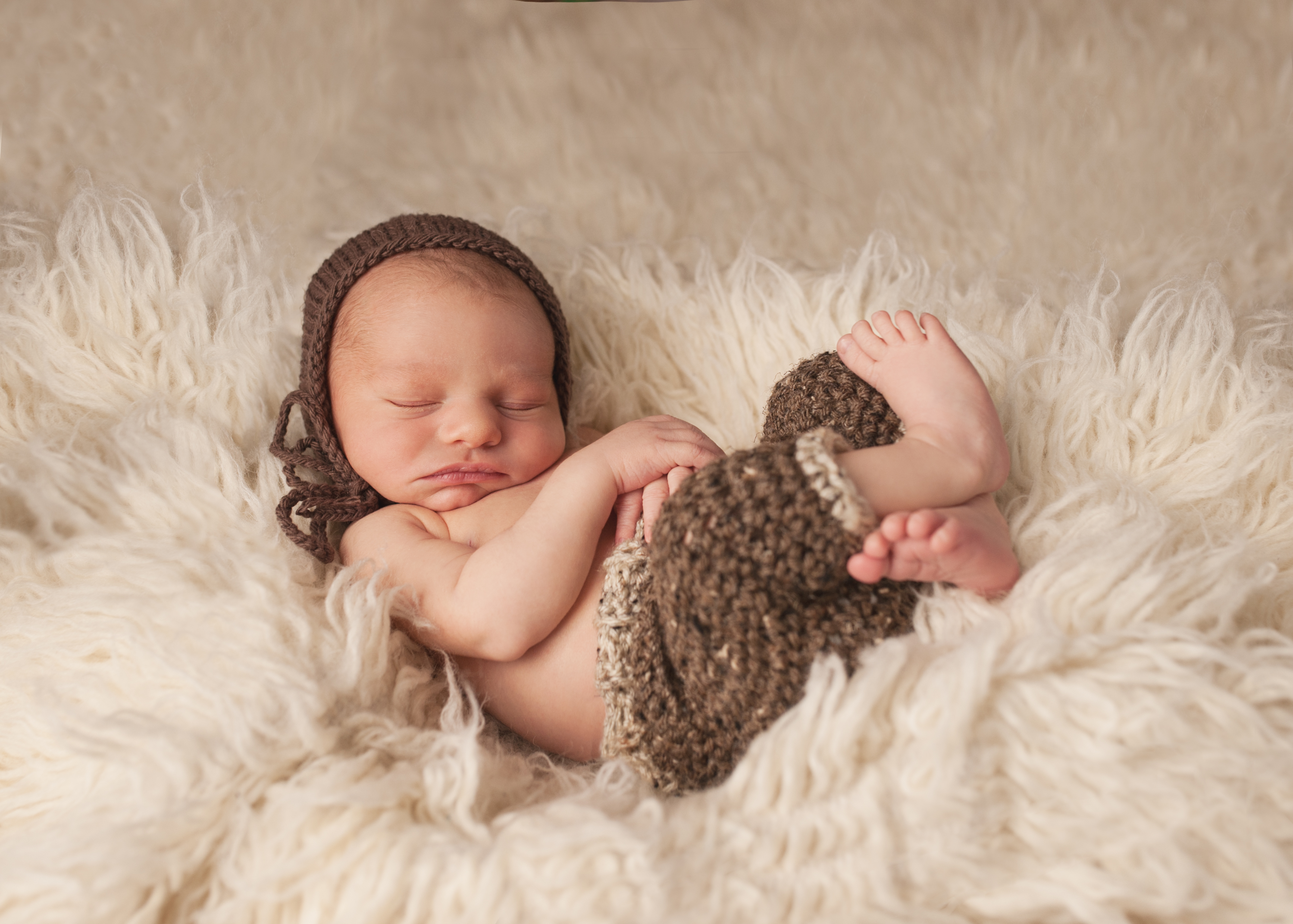 newborn boy in brown knit pants