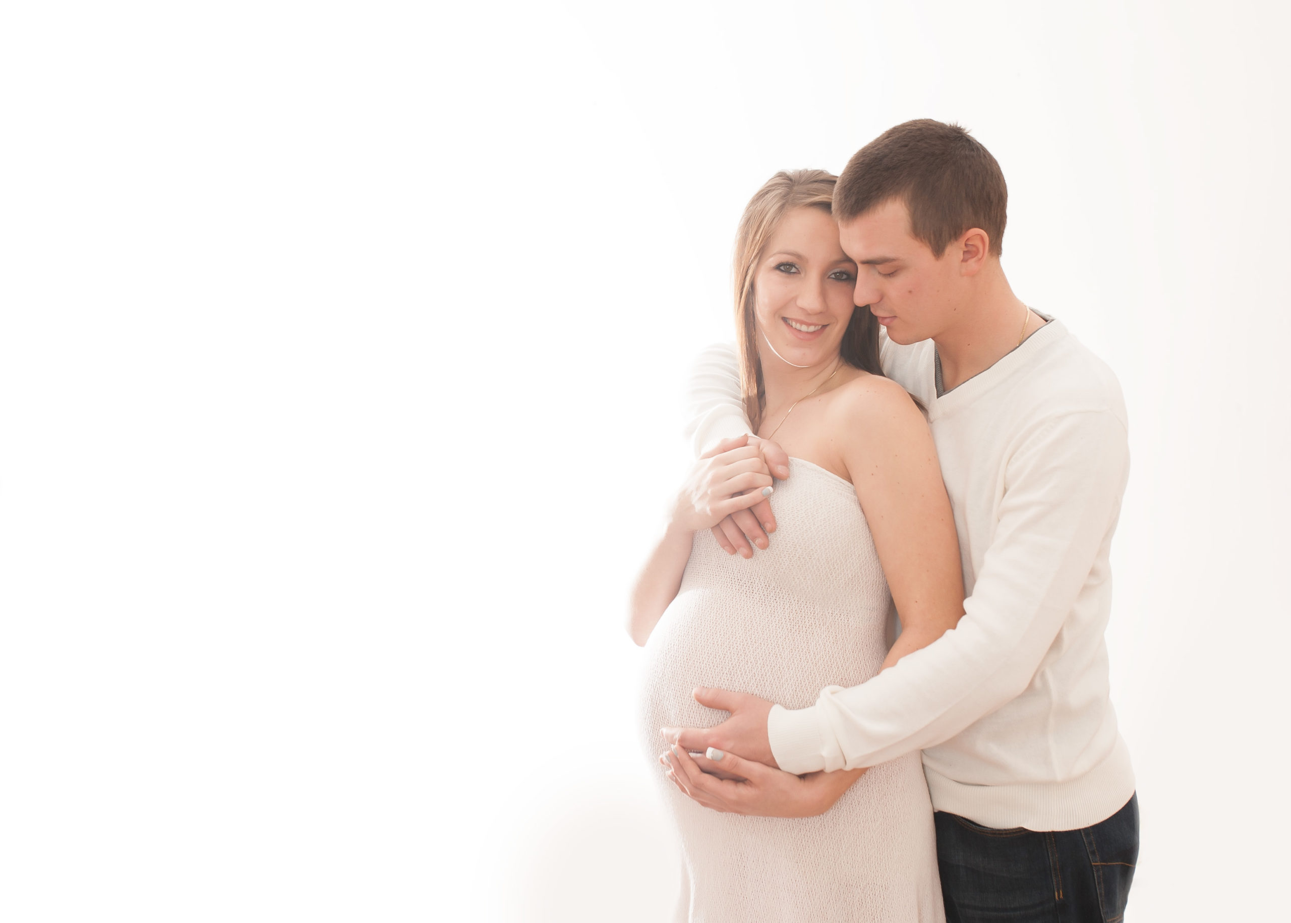 couple who are backlit pose for camera