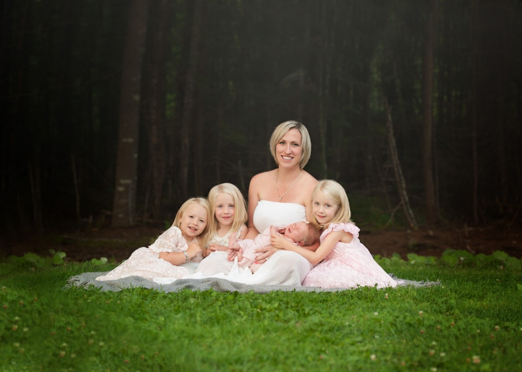 Saint John photographer moms and her four daughter sitting on the grass