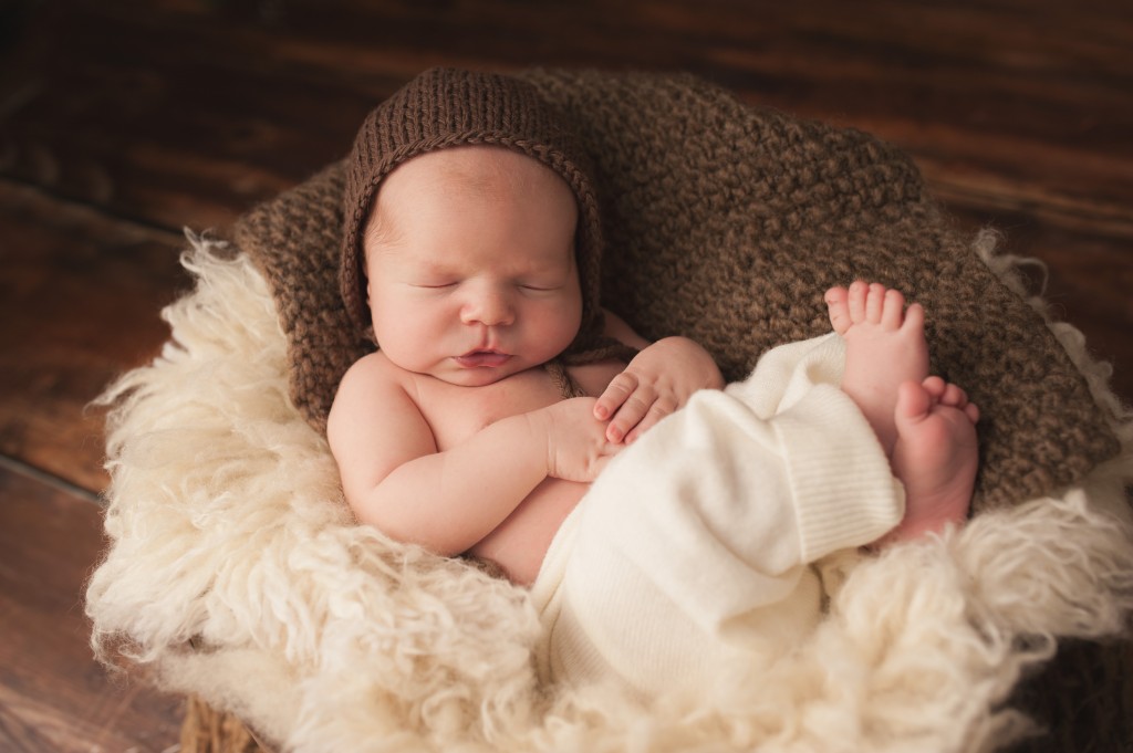 Sweet newborn boy on neutral colours