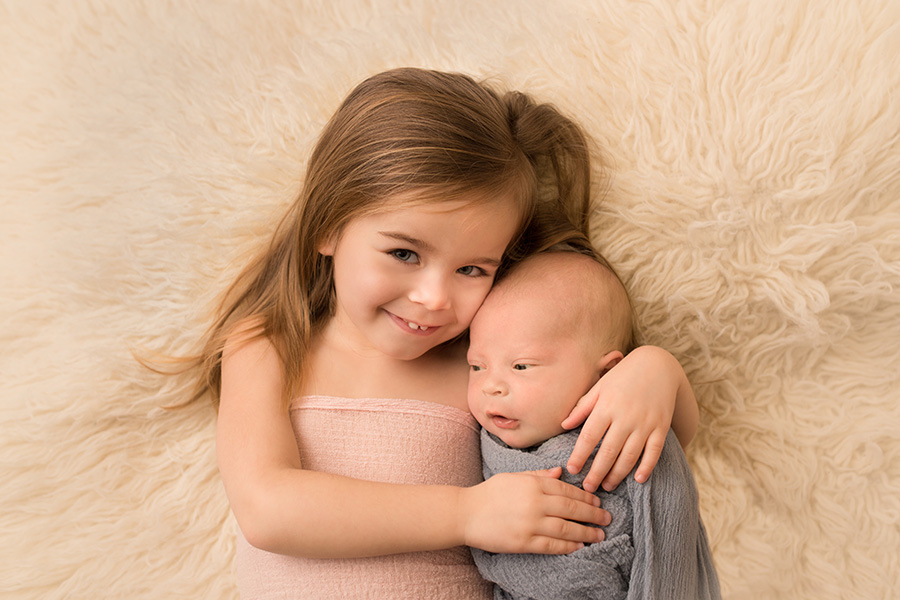 Saint John Photographer- big sister holding her new baby brother