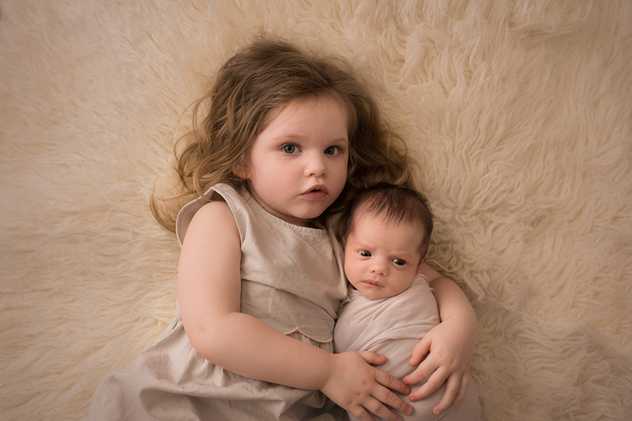 Saint John Photographer - big sister holding her new baby sister