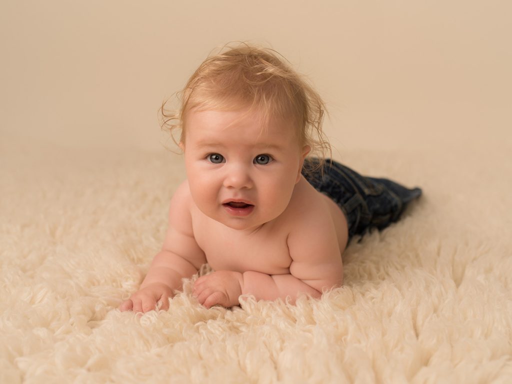 Baby laying on cream rug | Saint John Baby Photographer 