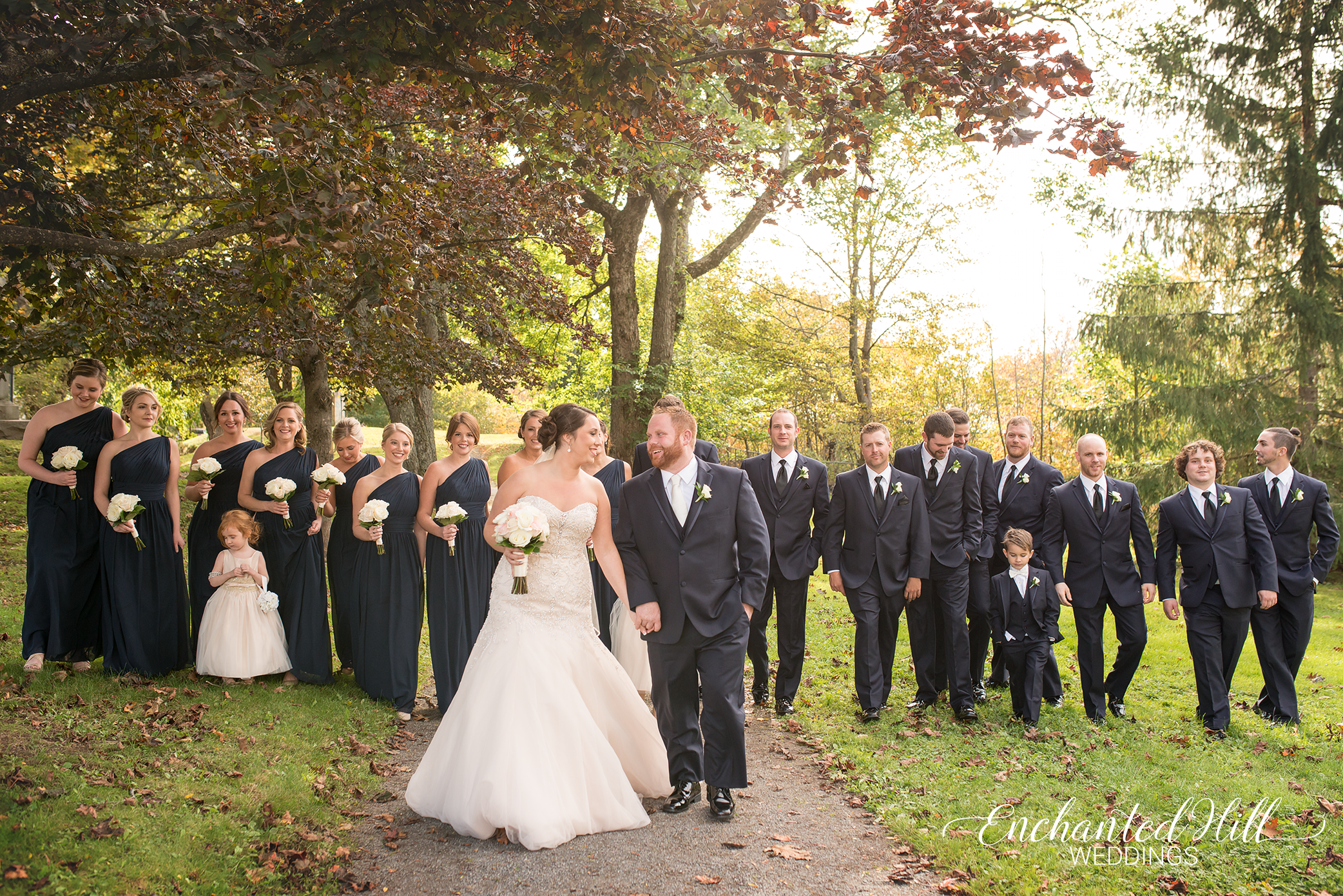 large wedding party walking through park in Saint John