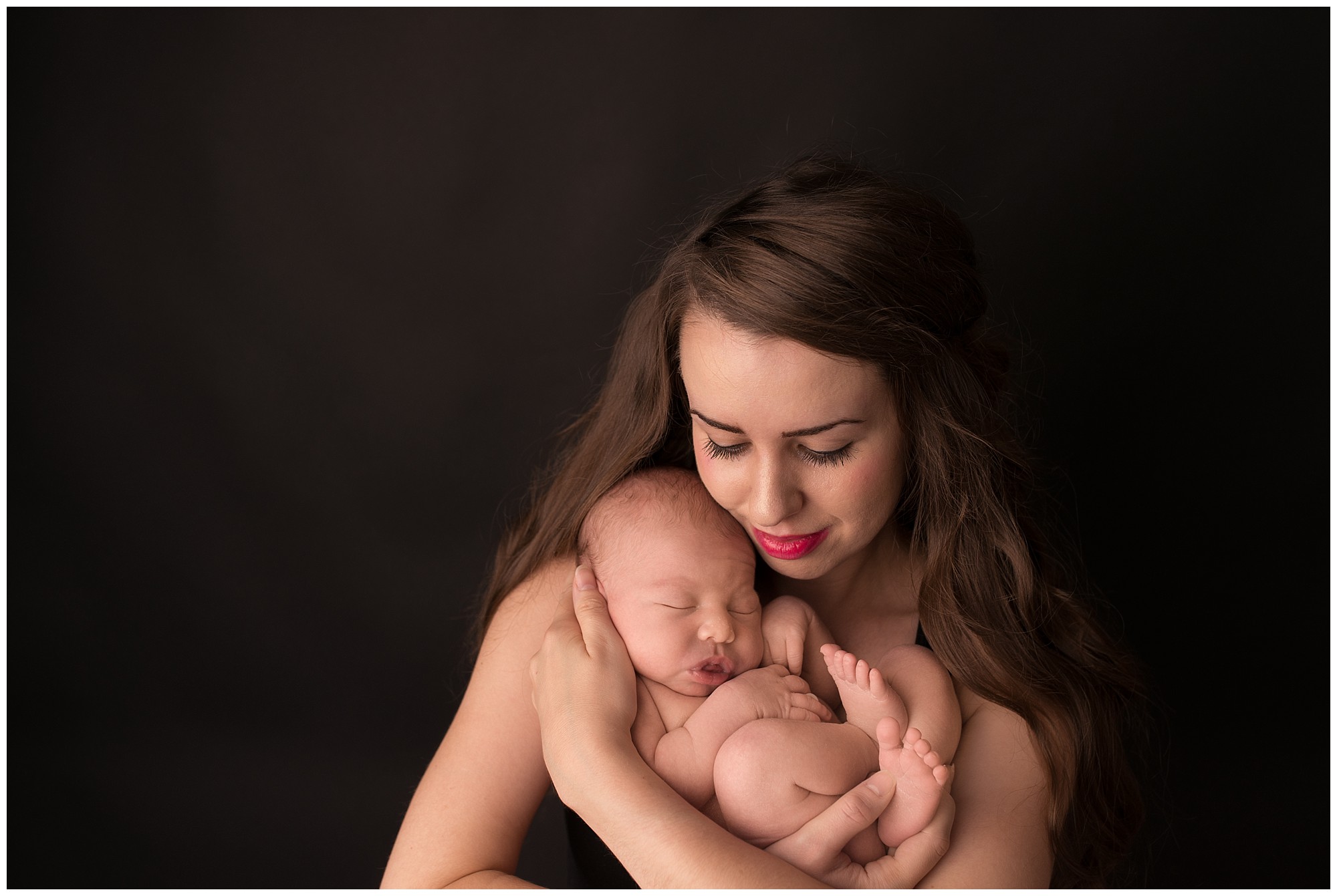 loving mother cradling her new baby in her arms