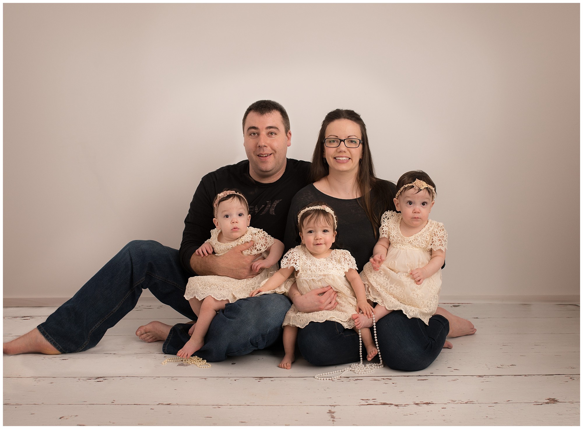 Saint John family sitting together in a studio for a family picture 