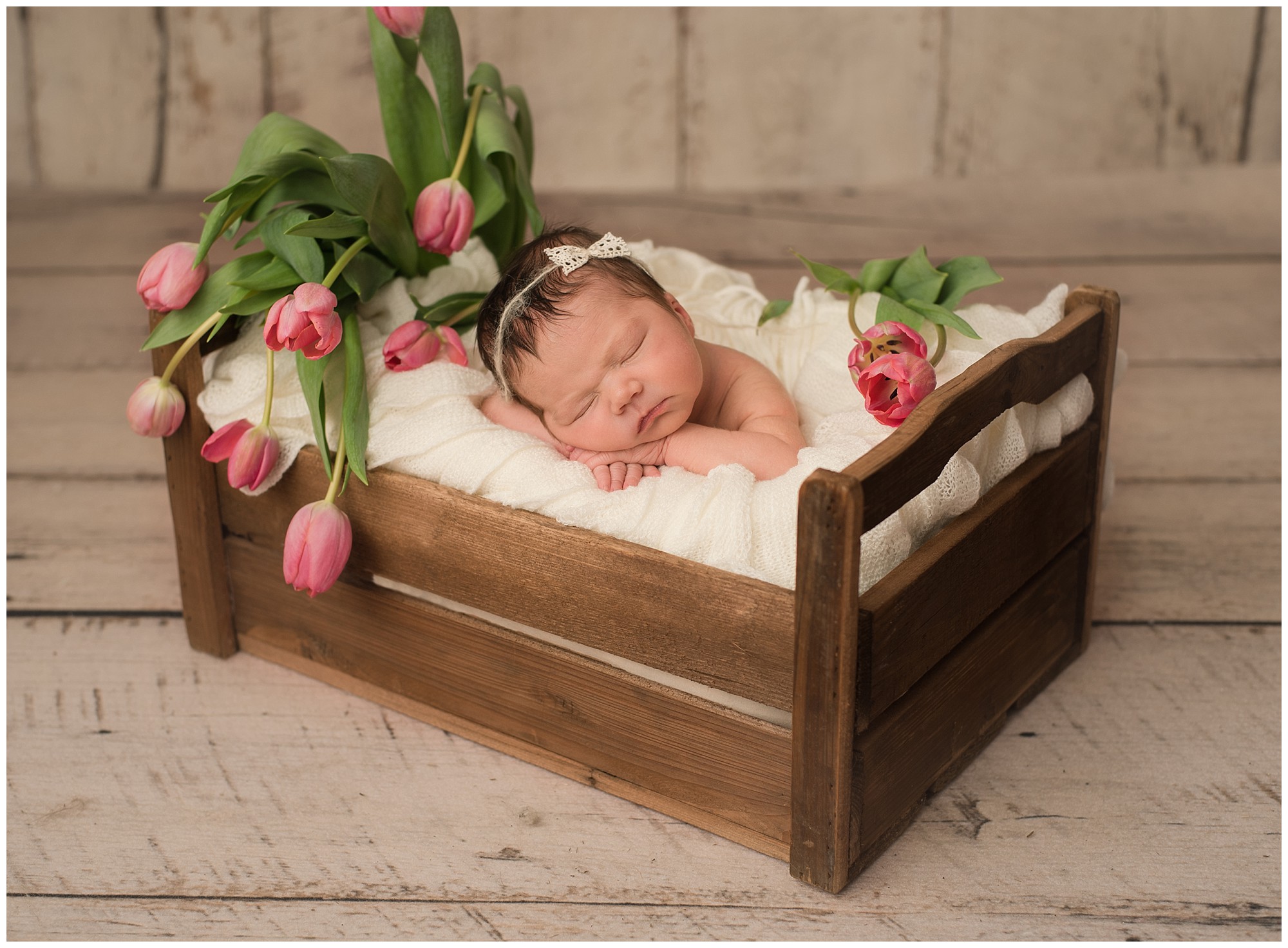 newborn baby girl with tulips