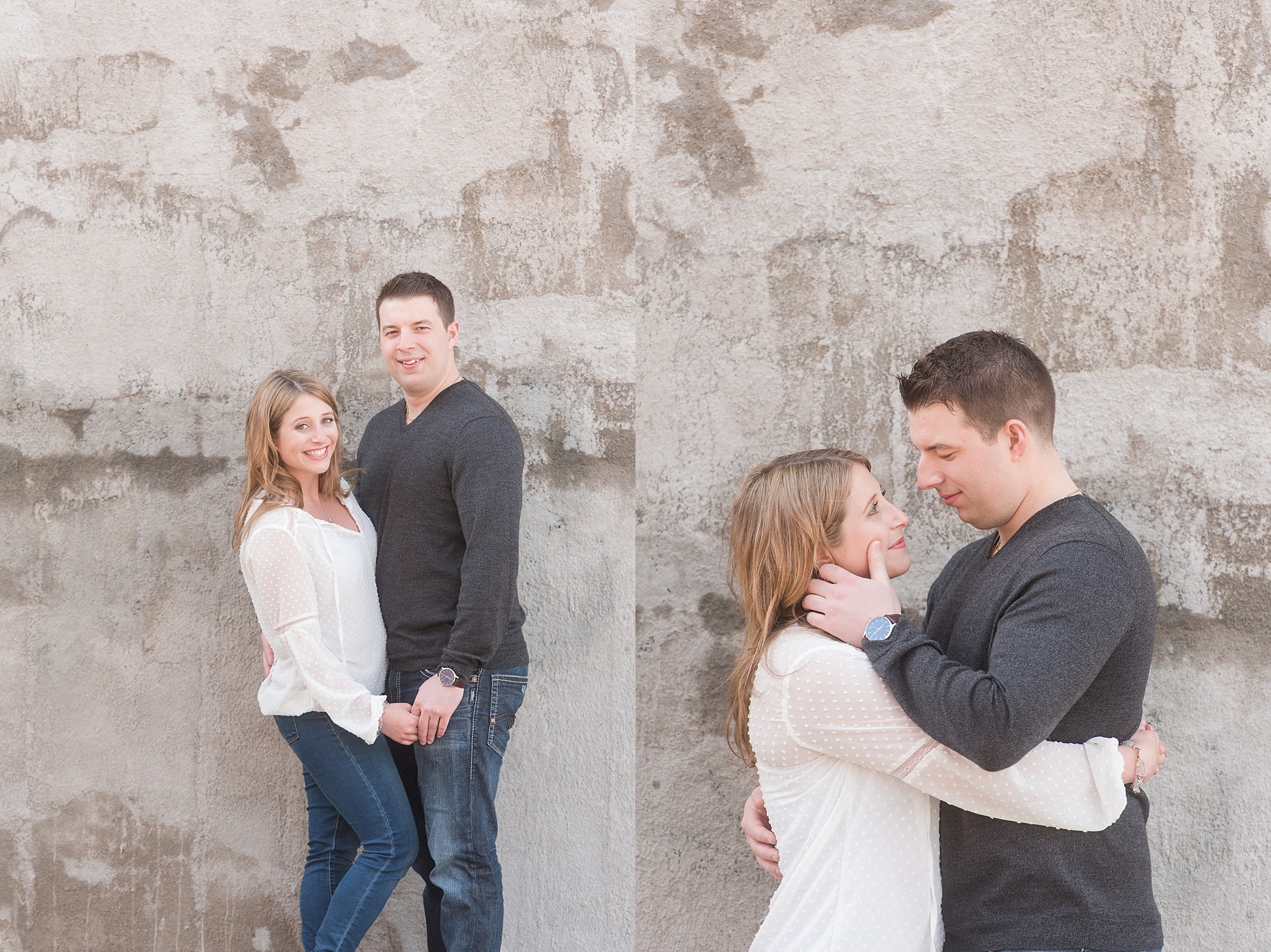 young couple laughing in from of a wall