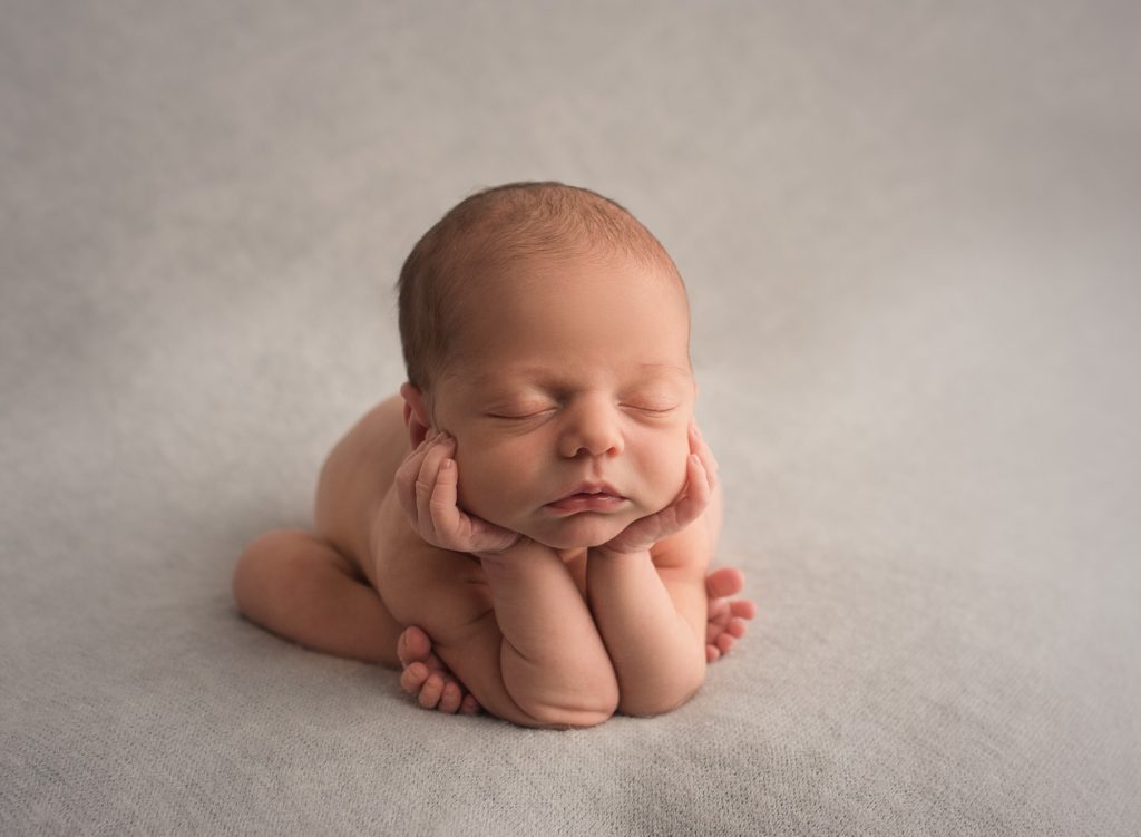 newborn session in Saint John posed on a blanket doing the froggie pose