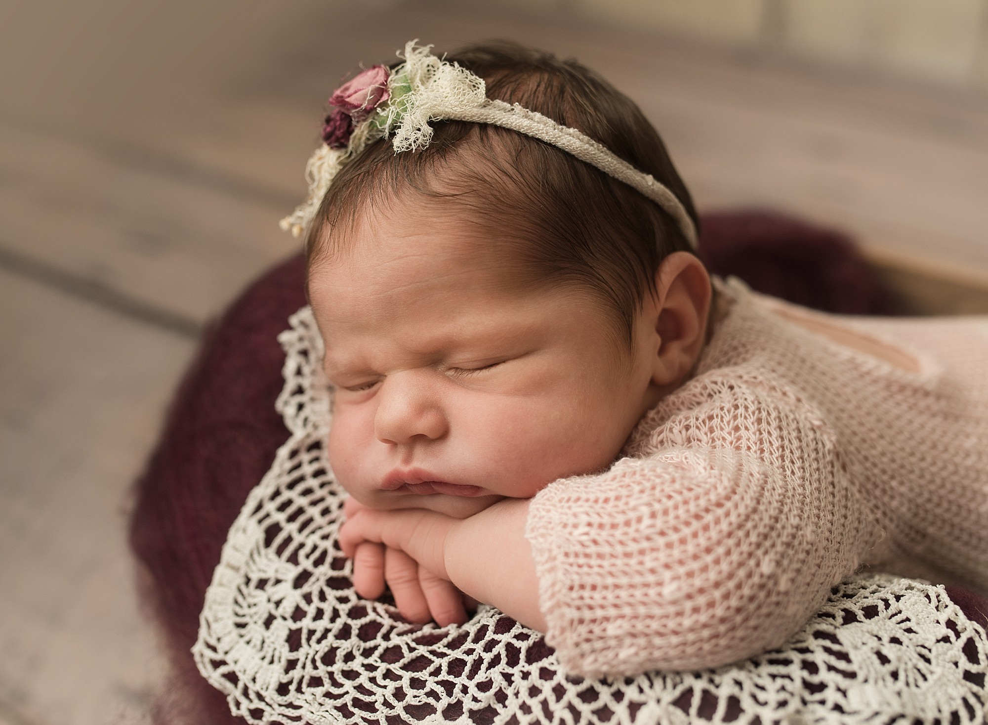 baby girl during a photo shoot wearing a soft pink romper