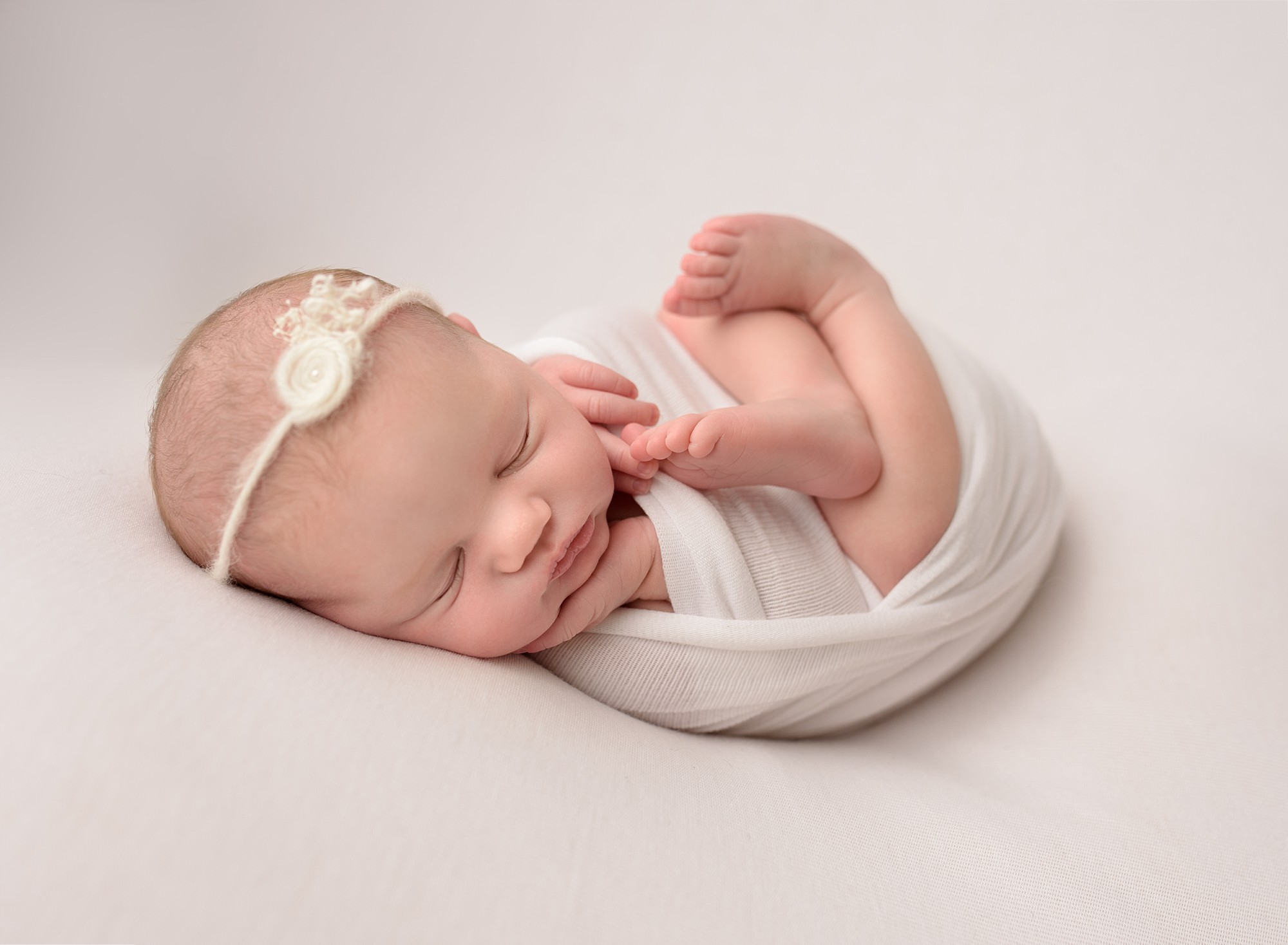 baby girl from quispamsis sleeping wrapped in white