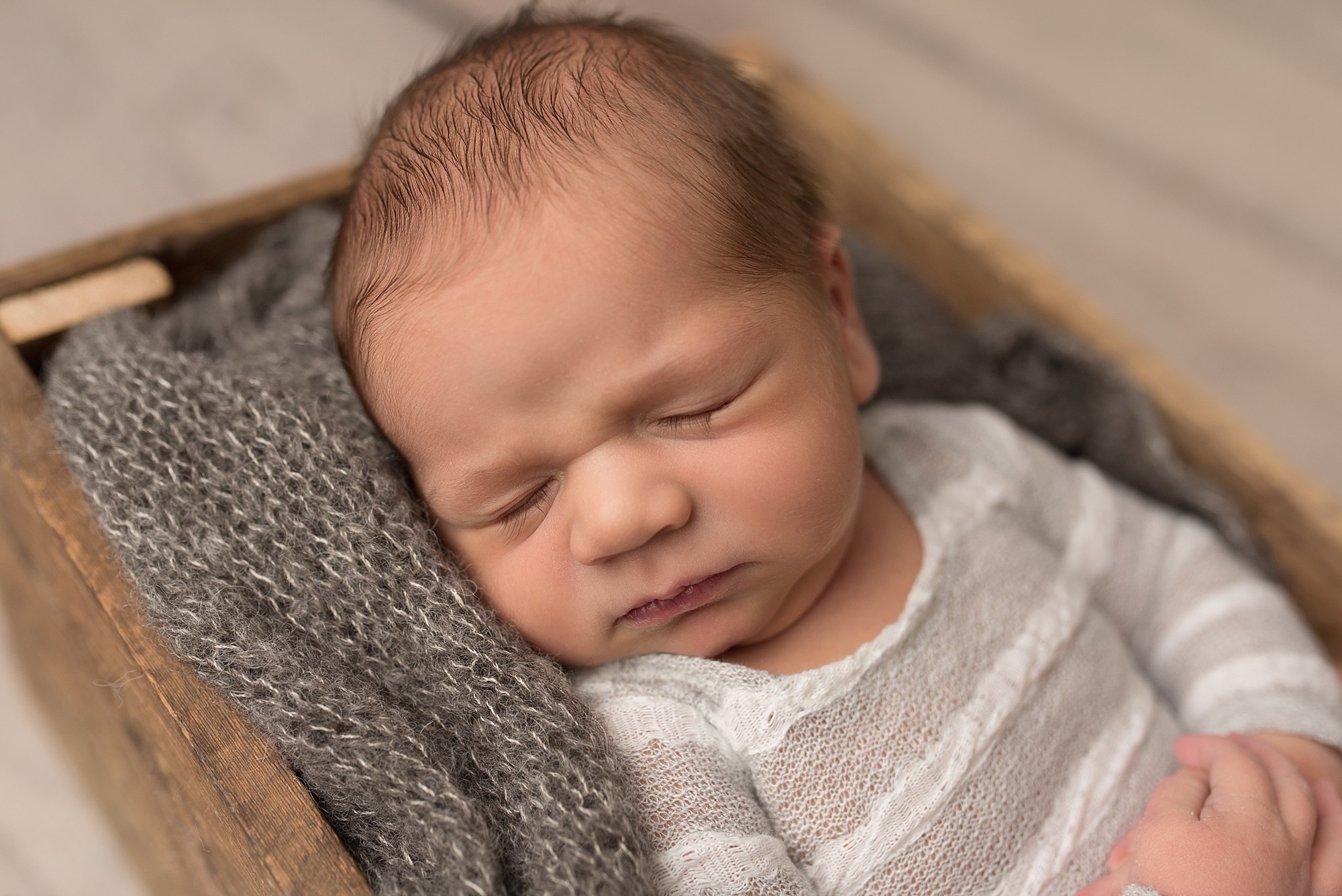 a baby sleeping with his eyes closed and long lashes on his cheeks